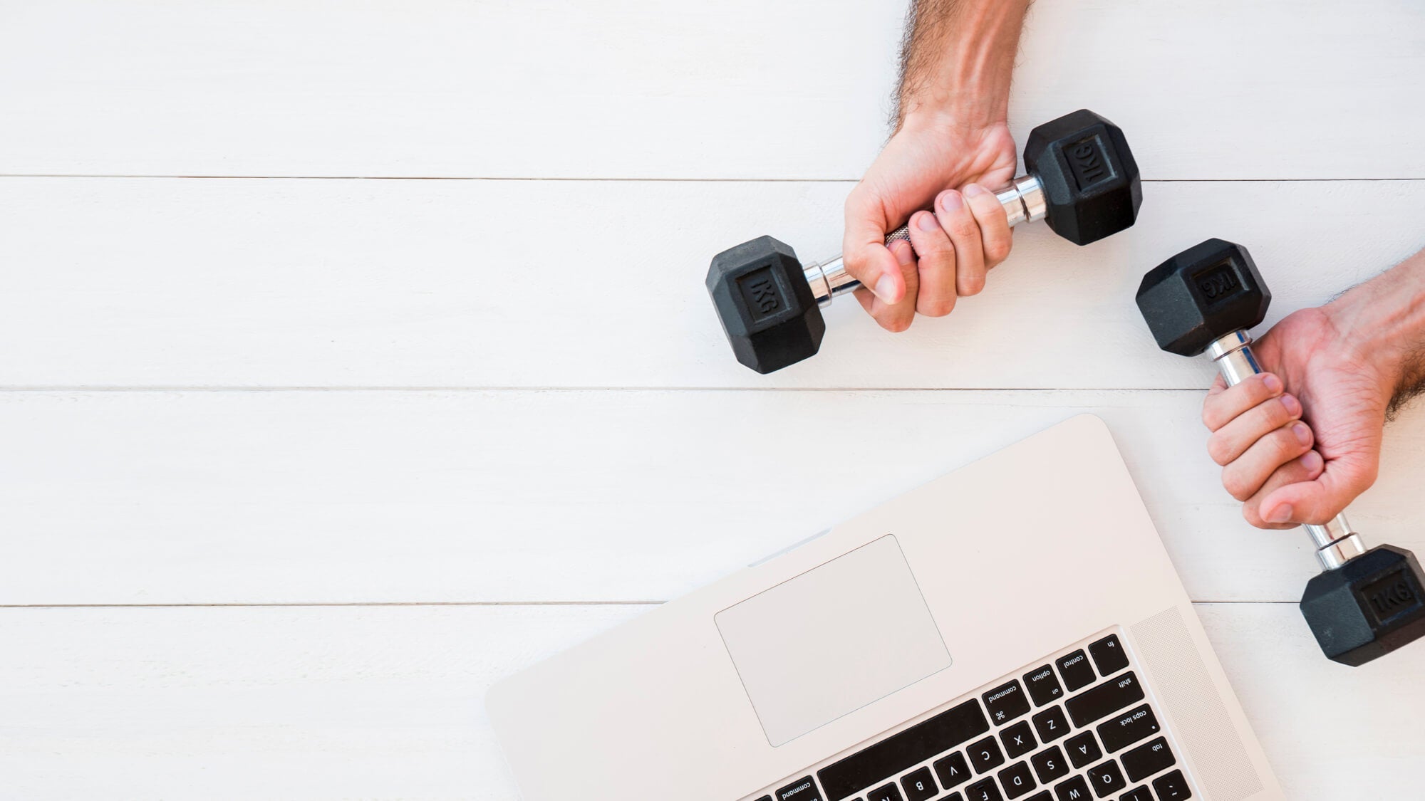 Two hands holding dumbbells